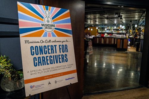 A sign welcoming caregivers to our concert. In large text, it reads, 