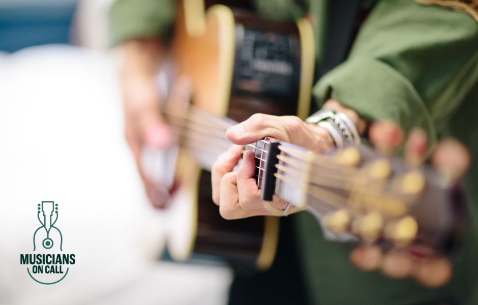 a closeup of older-looking hands playing a guitar. the musicians on call logo is in the corner