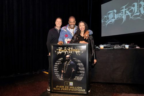 Mitch Glazier, Busta Rhymes, and Michele Ballantyne pose with plaque