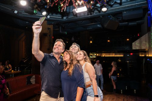 Charles Esten taking a selfie with caregivers