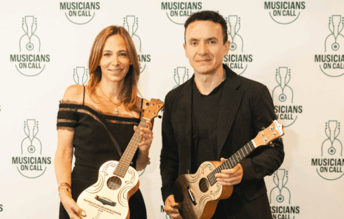 Picture of Michelle Frohlich-Klinger and Fonseca posing with golden ukuleles
