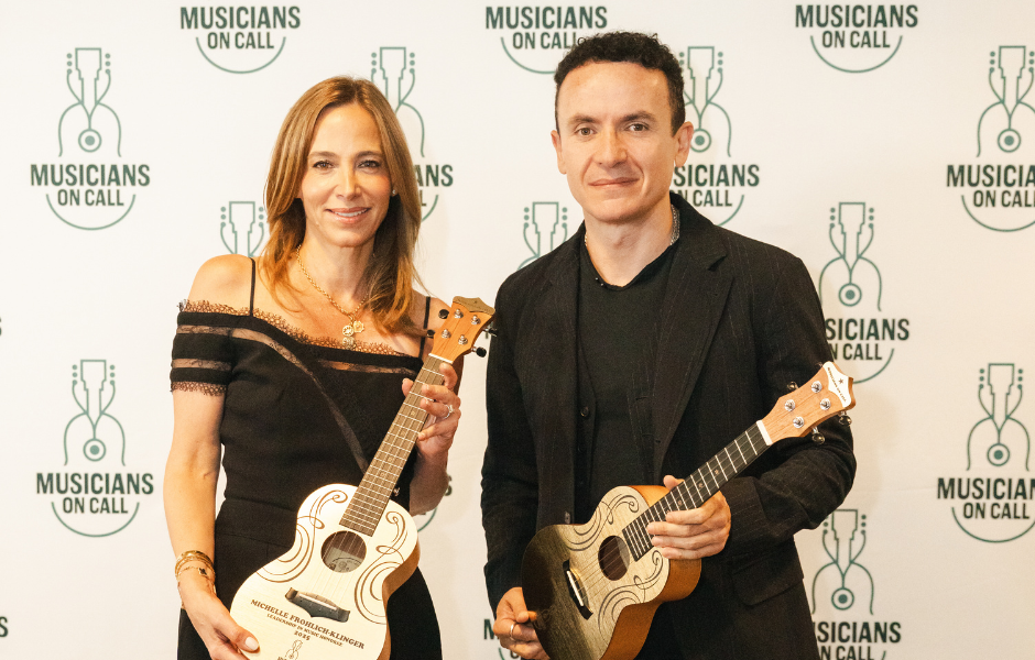 Picture of Michelle Frohlich-Klinger and Fonseca posing with golden ukuleles