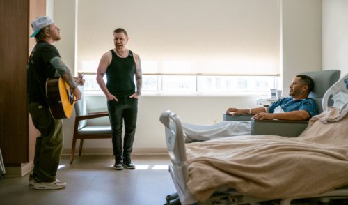 Picture of Shinedown singing to a hospital patient