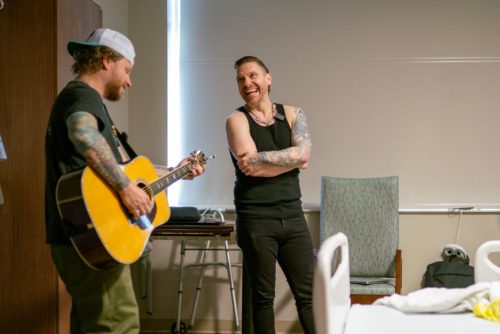 Photo of Shinedown singing to a hospital patient