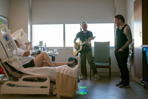 Photo of Shinedown singing to a hospital patient