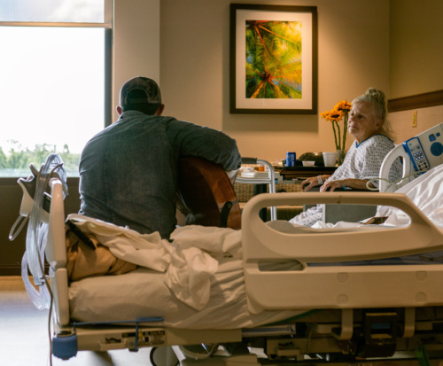 Michael Ray singing to a hospital patient