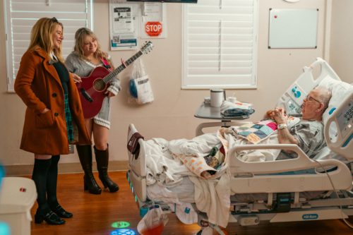 Minnie Murphy and Aliyah Good singing to a Veteran