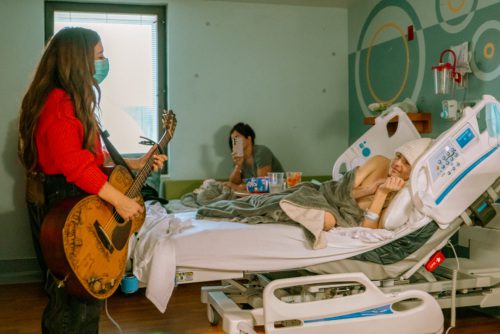 Photo of Tenille Townes singing to a hospital patient