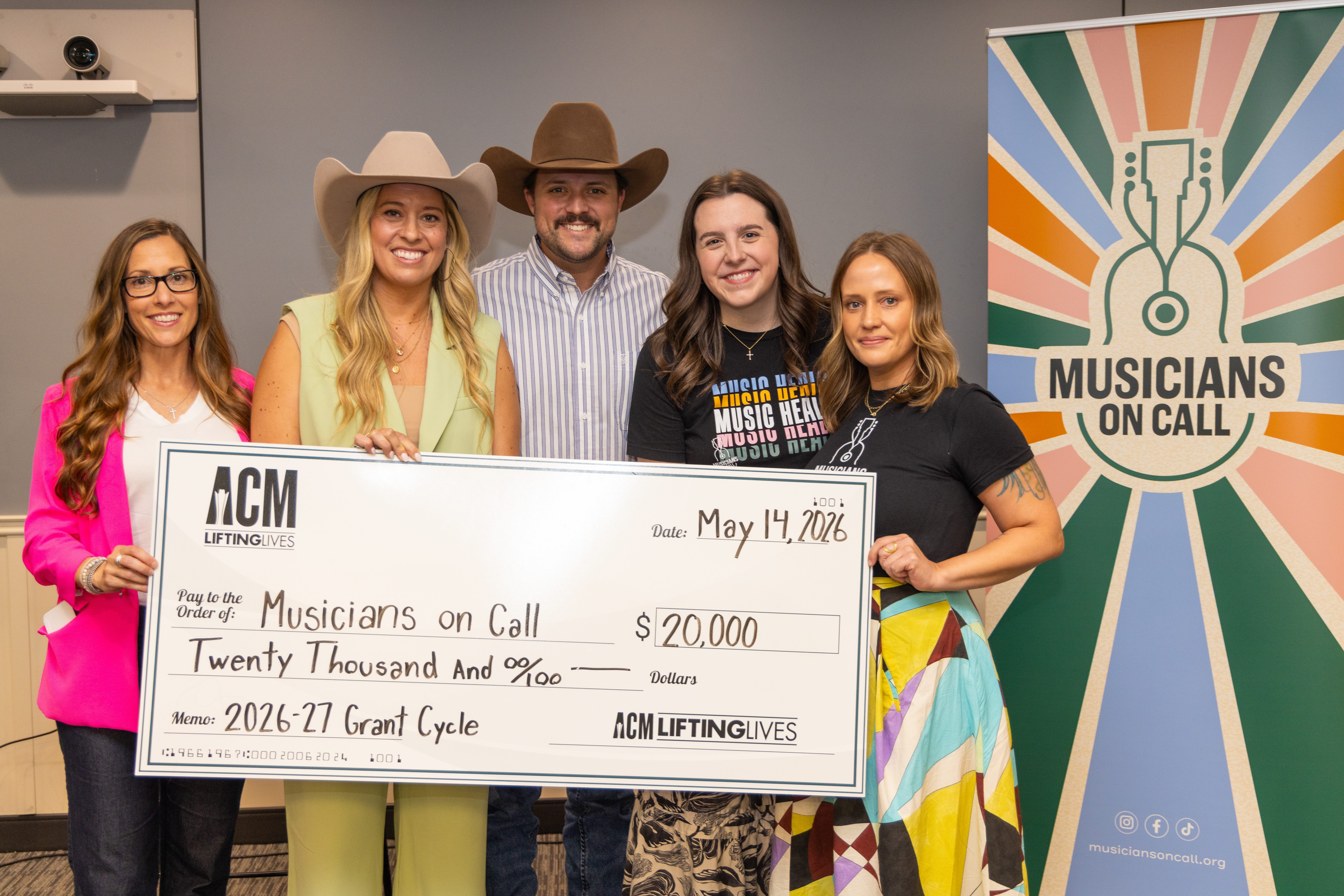 Katy Epley, COO; Taylor Wolf, Executive Director ACM Lifting Lives; Walker Montgomery, Abby Tannler, Programs & Activations Manager; Emiley Roye, Program Manager standing with a check.
