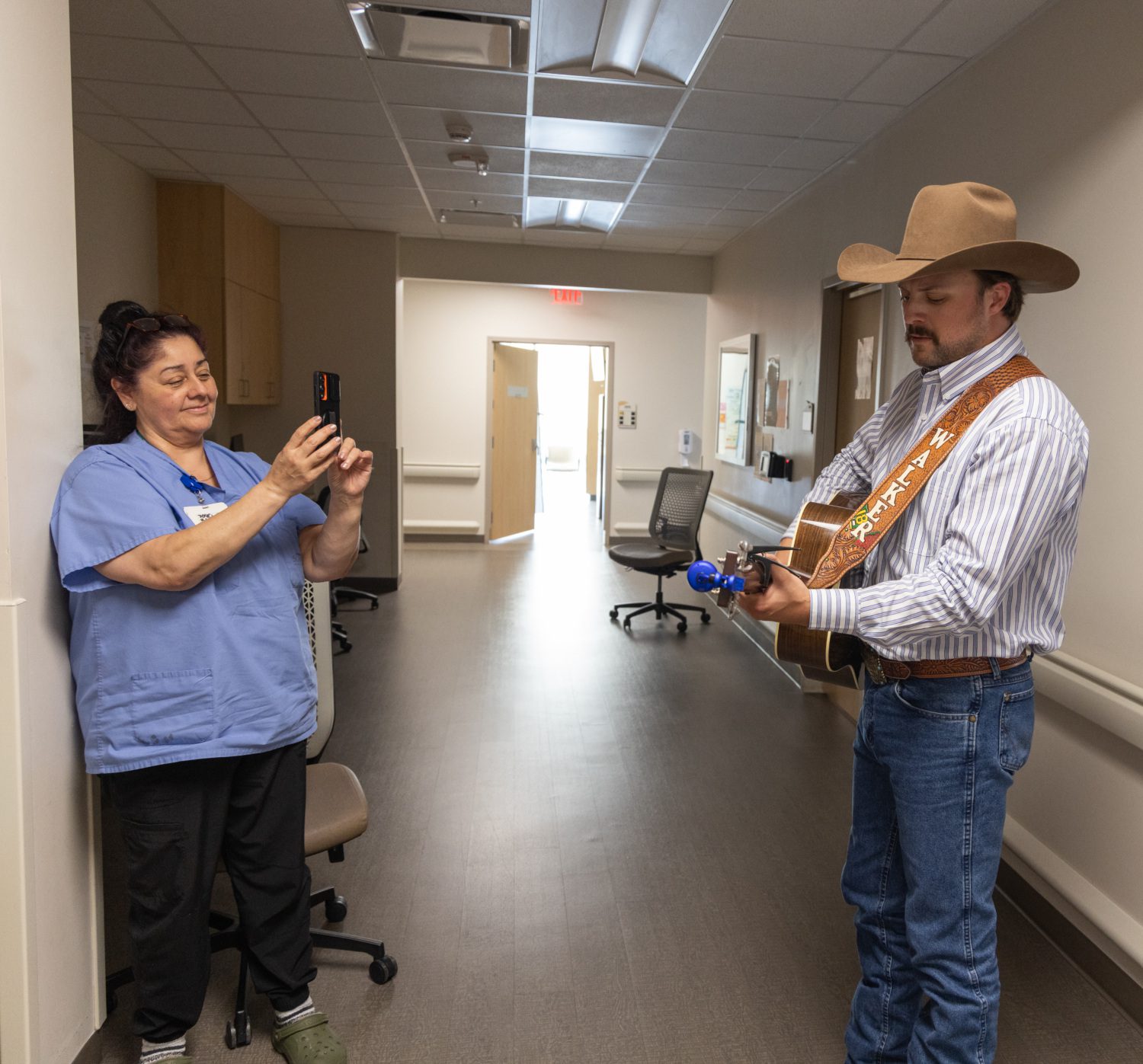 Walker Montgomery plays guitar in the hospital hallway