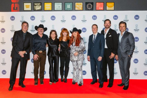 Vince Gill, Shane Tarleton, Martina McBride, Reba McEntire, Wynonna, Mitch Glazier, Pete Griffin, and Charles Esten pose on the red carpet for Musicians On Call's Music Heals Live! event.