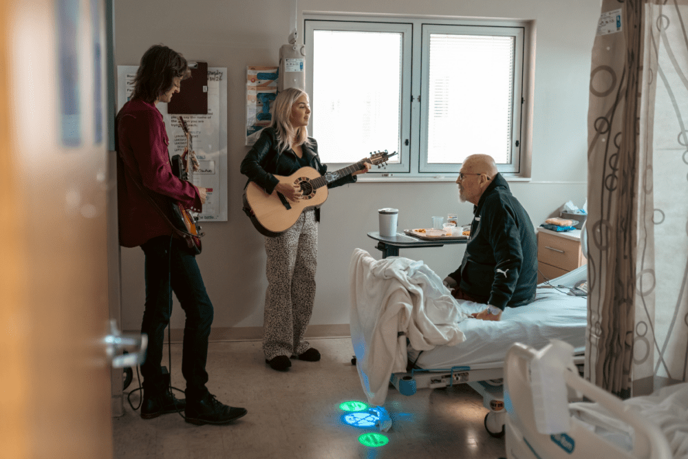 Maggie Rose sings for a hospital patient