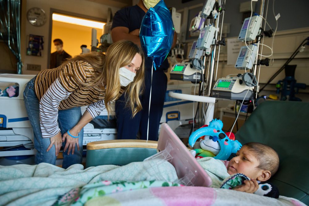 Photo of Kristen Bell talking to a hospital patient