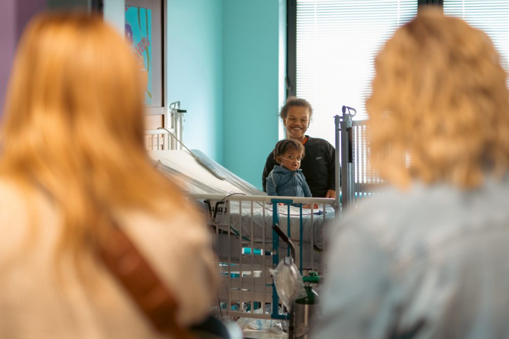 Photo of Tigirlily Gold singing to hospital patient