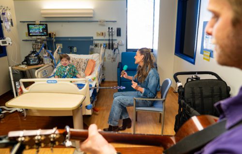 Photo of Kelsea Ballerini singing to a hospital patient