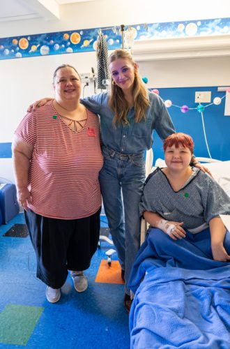 Kelsea Ballerini taking a photo with hospital patients